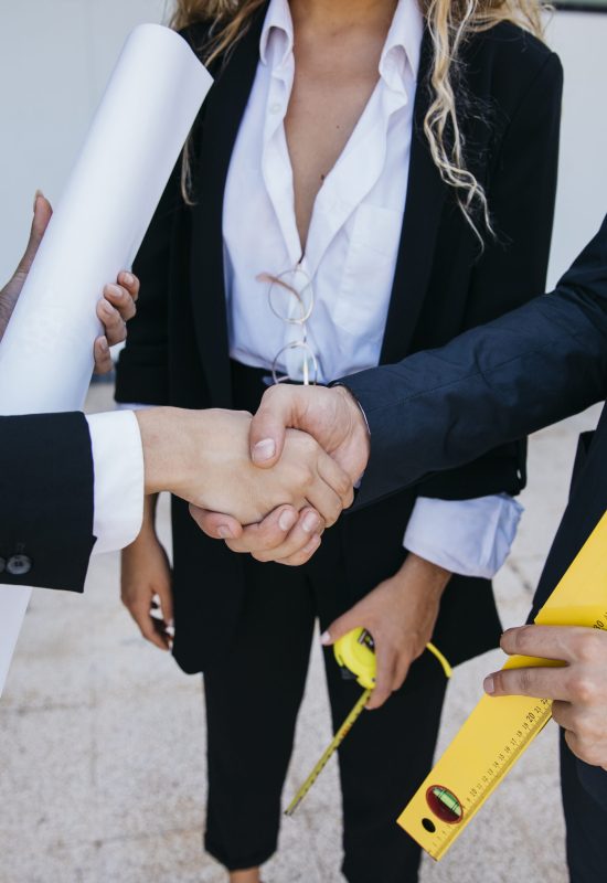 businessman-with-level-businesswoman-shaking-hands